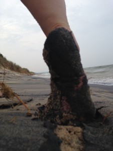 black sand clumped on my foot