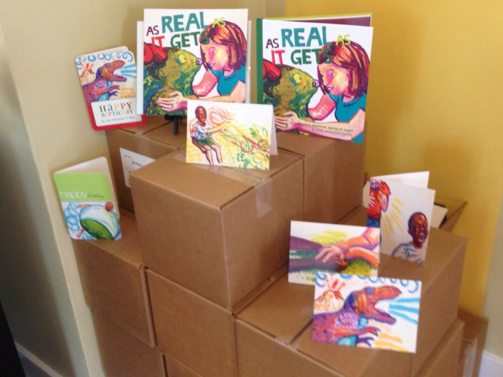 books and greeting cards propped on the pile of boxes in my dining room