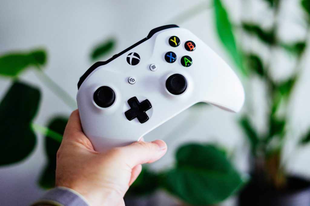 An image of hand holding an Xbox controller