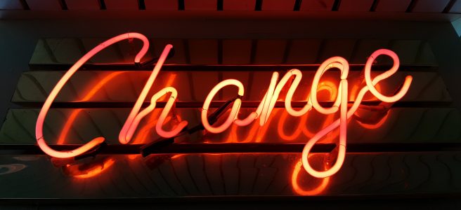 A neon sign reads CHANGE.